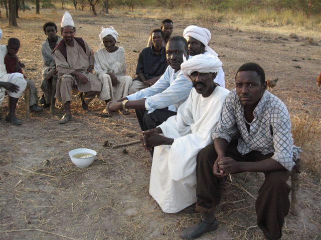 African market traders with agricultural produce in a busy open-air market